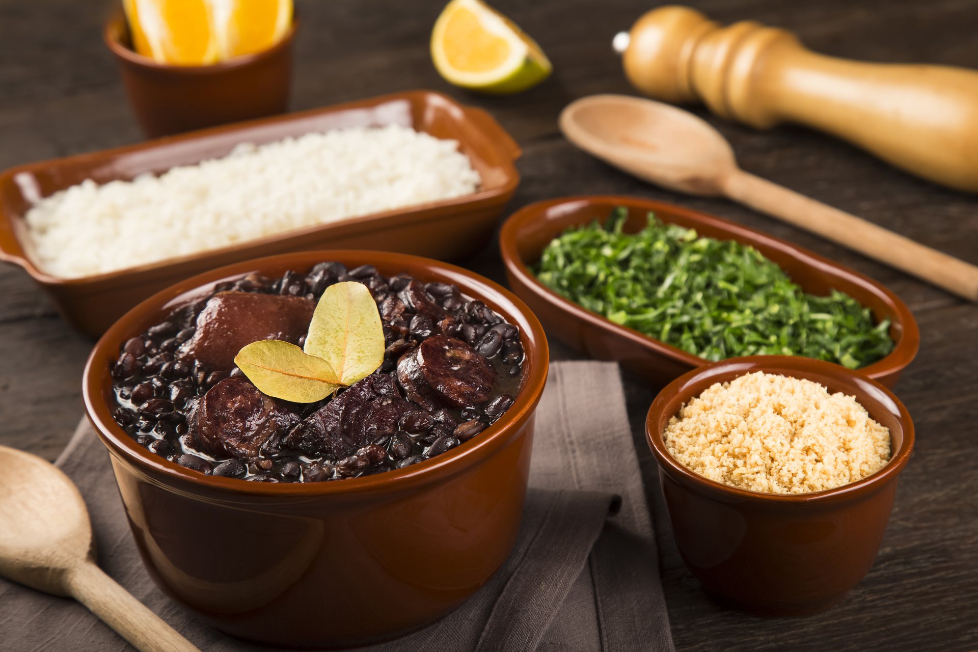 Brazilian feijoada with rice, farofa, couve and orange